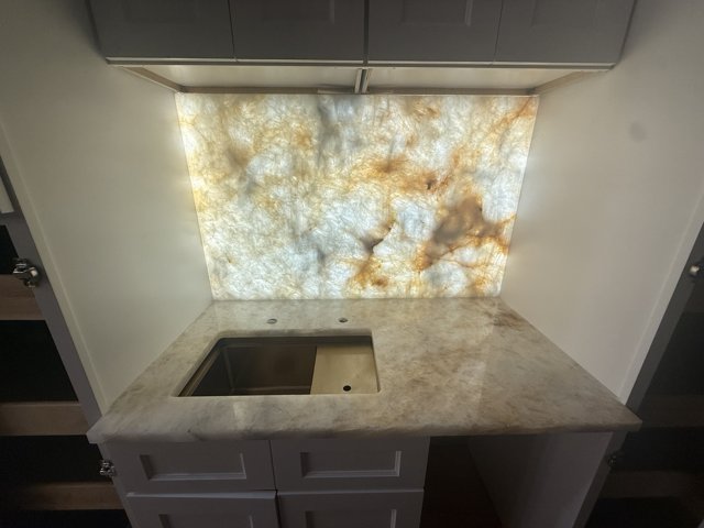 Backlit bar backsplash and sink countertop